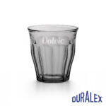 Verre Duralex Picardie 25 cl gris avec le logo Volvic en marquage clair au-dessus des facettes.